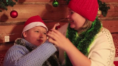 Boy and mom in red caps close-up have fun on christmas. Stock Footage 144681575