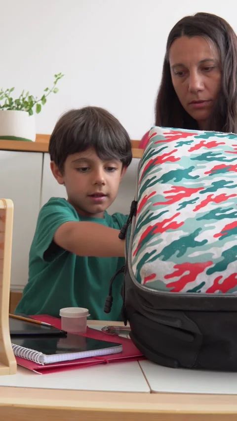Boy and mother getting backpack ready to school. Stock Footage 279337785