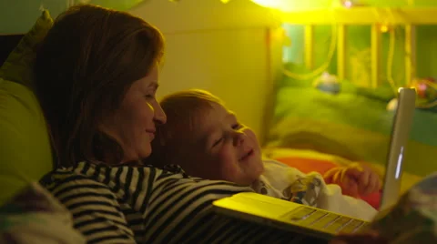 Boy and Mother Watching Bedtime Story in Laptop Stock Footage 56727253