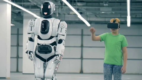 A boy and a robot moving hands, close up. Modern cyborg with children. Vidéo 102325766