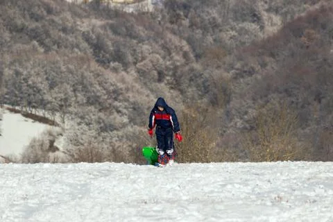 A boy and sledge Stock Photos