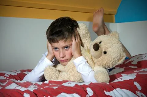 Boy angry on bed Stock Photos