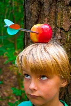 Boy with apple on his head Stock Photos