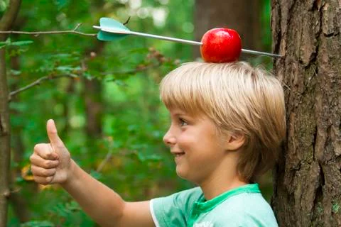 Boy with apple on his head Stock Photos