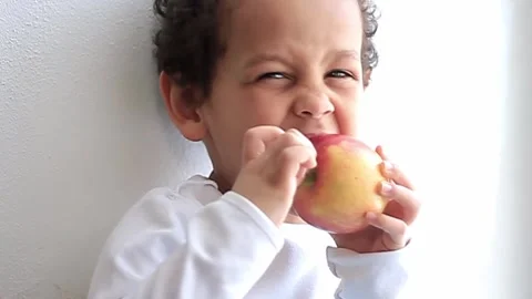 Boy with apple on white background with people stock video stock footage Stock Footage 321939749