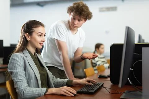 Boy asking teacher about computer problem during lesson Stock Photos