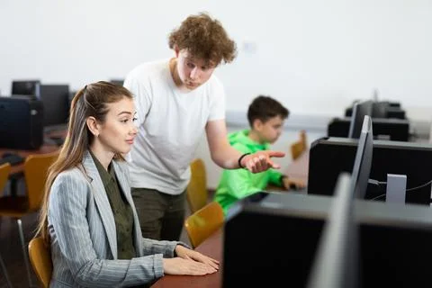 Boy asking teacher about computer problem during lesson Stock Photos