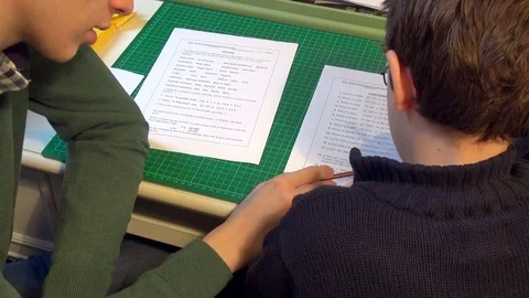 Boy asks older brother for help on math homework Stock Footage 71962100