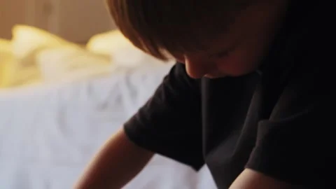 A boy assembles a car from a construction set Stock Footage 252382345