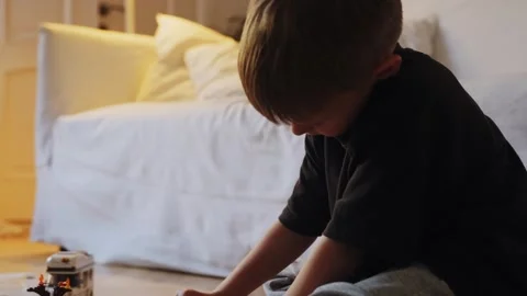 A boy assembles a car from a construction set Stock Footage 252382355