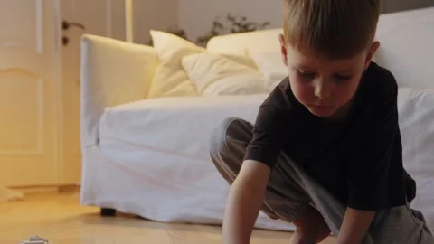A boy assembles a car from a construction set Stock Footage 252382384