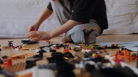 A boy assembles a car from a construction set Stock Footage 252382406