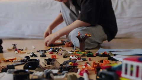 A boy assembles a car from a construction set Stock Footage 252382415
