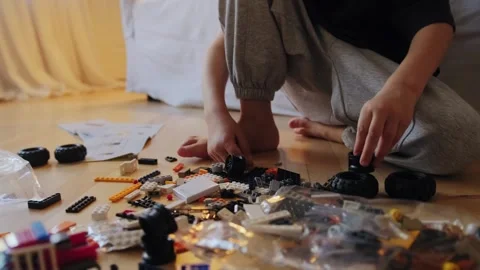 Boy assembling construction kit at home Stock Footage 252382334