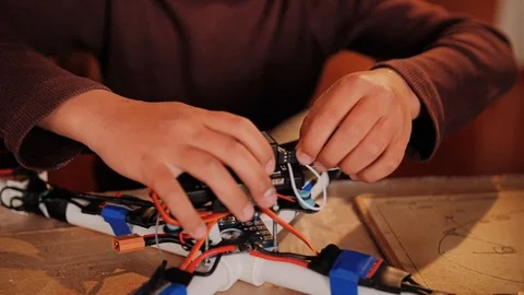 The boy is assembling a quadrocopter of his own making. Young engineer Stock Footage 108960565