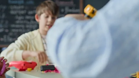 Boy Assembling Robotic Toy during School Science Lesson Stock Footage 339199436