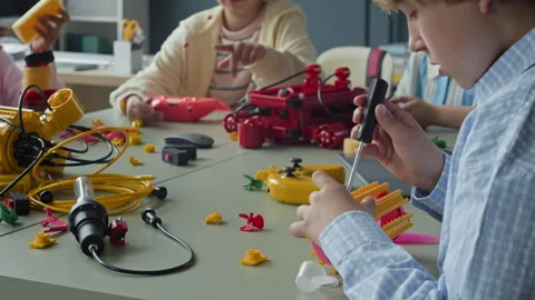 Boy Assembling Robotic Toy with Screwdriver in Stem Class Stock Footage 339199468