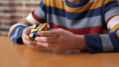 A boy assembling the Rubik's cube. Stock Footage 105112081