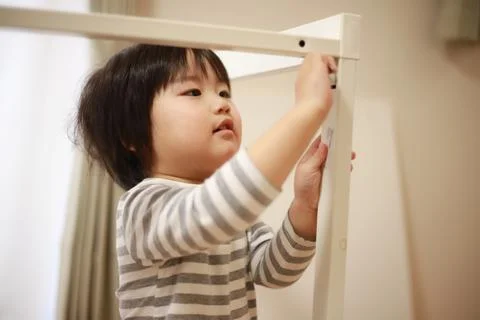 Boy assembling a table ​ Stock Photos