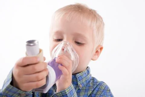 Boy with asthma inhaler Stock Photos