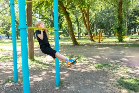 Boy athlete on horizontal bars Stock Photos