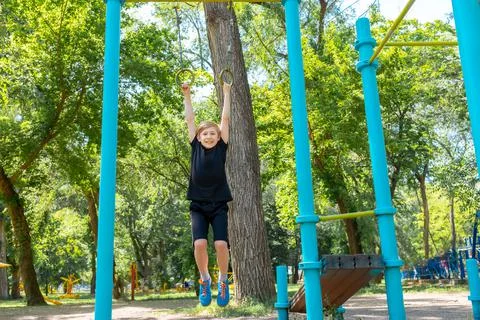 Boy athlete on horizontal bars Stock Photos