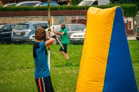 Boy attacking his opponent in a game of archery tag Stock Photos