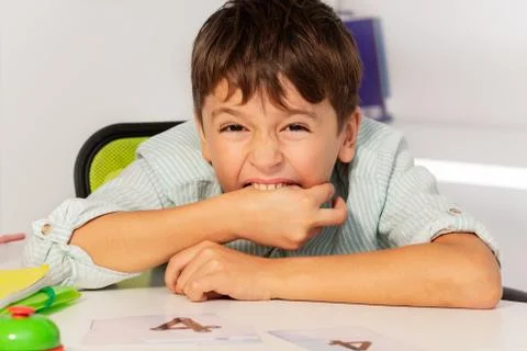 Boy with autism bite hands at development class Stock Photos