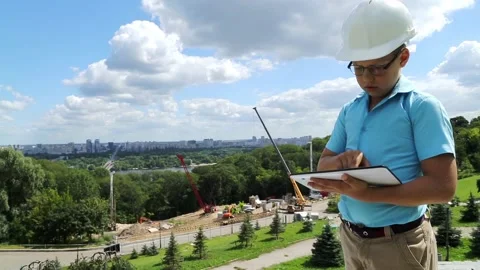 The boy on the background of construction works with a tablet Stock Footage 97265701