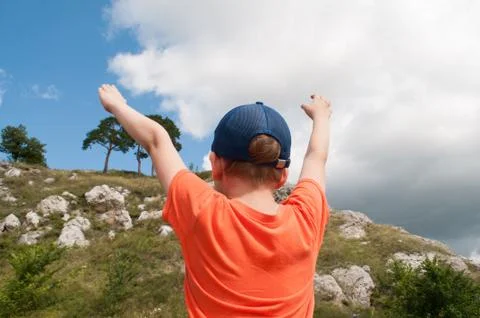Boy on a background of mountains, the concept of man and nature Stock Photos