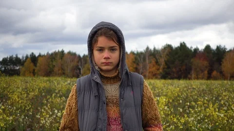 A boy on the background of a paradoxical flowering field in the fall. Video stock 99036574
