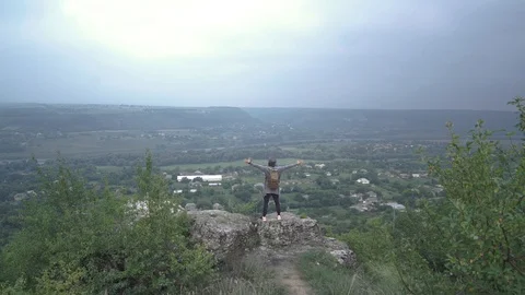 A boy with a backpack and hat is glad that he has arrived at his destination. Stock Footage 127159081