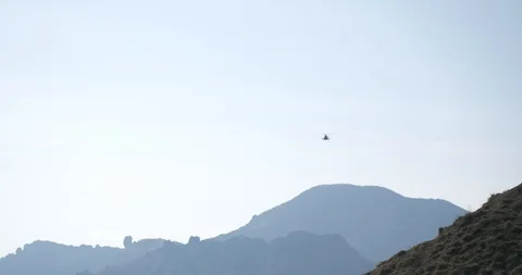Boy with a backpack climbs the mountain path Stock Footage 107672644