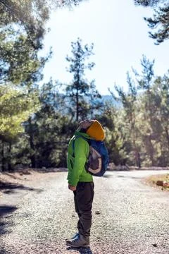 Boy with a backpack in the forest. The child is standing in the middle of the Stock Photos