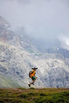 Boy with a backpack on a hike against the backdrop of the mountains. child tr Stock Photos