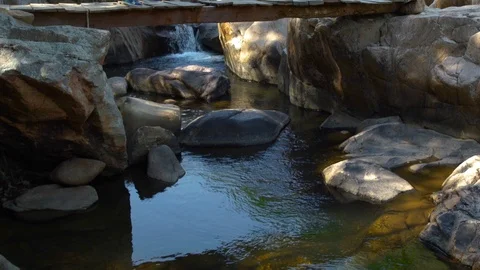 Boy with backpack walking on hanging bridge over mountain river while summer Stock Footage 90915040