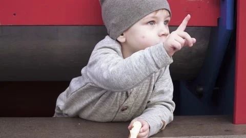 Boy with a bagel in park 스톡 동영상 140803015