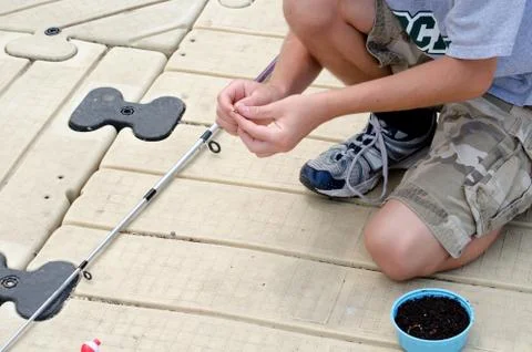 Boy baiting a hook Stock Photos