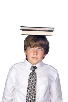 Boy balancing book on head Stock Photos