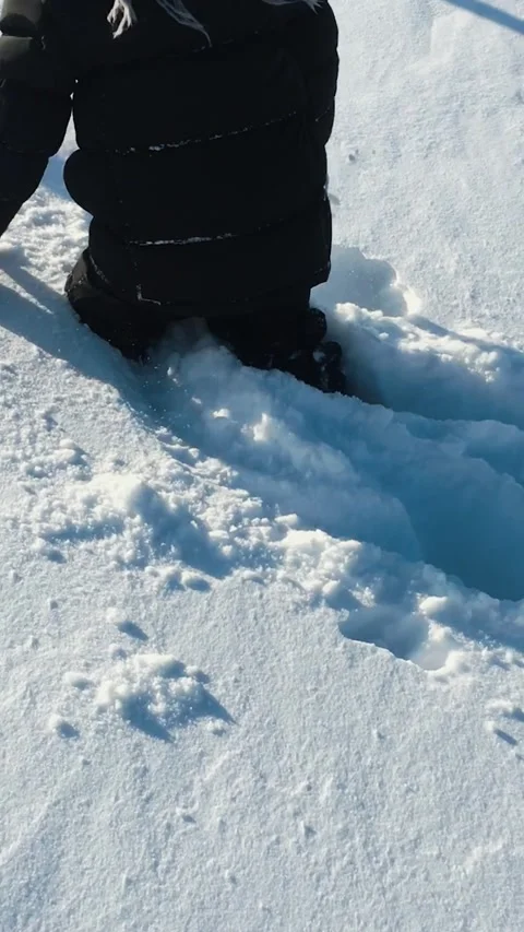 The boy barely makes his way through the snowdrifts. Slow Motion Stock Footage 165238735