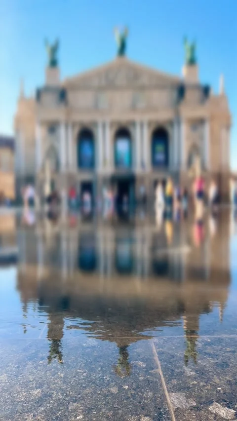 A boy in a baseball cap runs through the water of a pedestrian fountain. Stock Footage 340206749