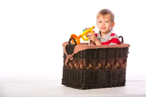 Boy in basket with toy Stock Photos
