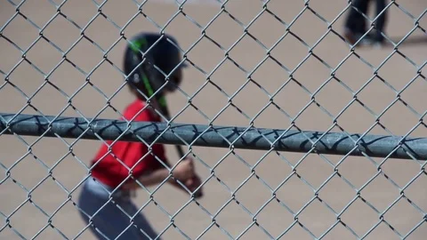 A boy is at bat while playing little league baseball, slow motion. Stock Footage 70434974
