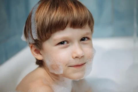 Boy in a bath with foam Stock Photos