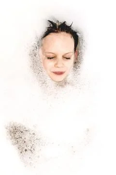 The boy in the bath with foam 写真素材