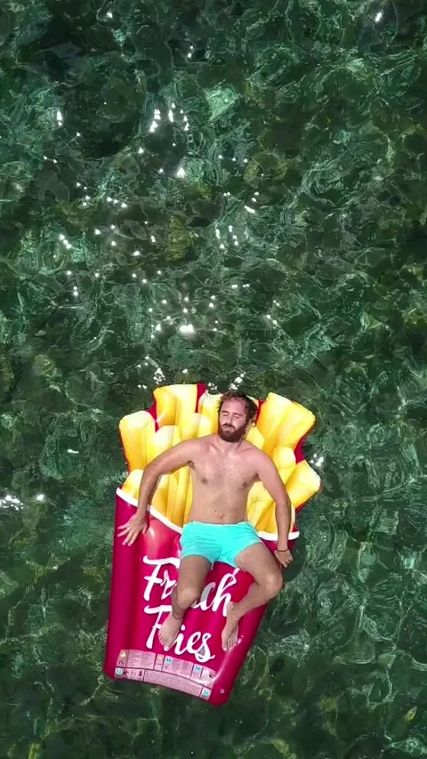 A boy bathes in the sea with a float Stock Footage 133535693
