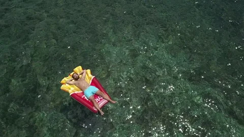 A boy bathes in the sea with a float Stock Footage 133535821