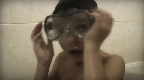 Boy in the bathroom plays a diver Stock-Footage 33854064