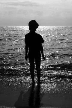The boy on the beach looking into the distance Stock Photos