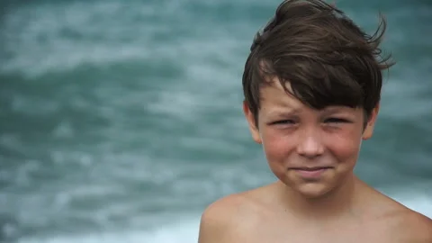 Boy on the beach, looking at the video camera Video stock 86041579